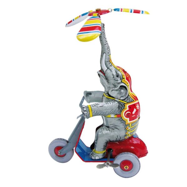 Éléphant en métal à remonter sur un scooter avec un objet en équilibre au dessus de sa trompe