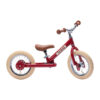 Cette belle draisienne rouge est un vélo sans pédales qui va initier l'enfant au vélo.