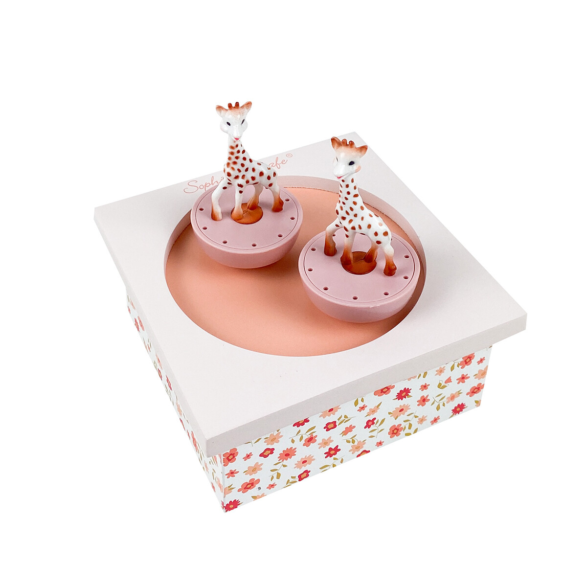 Boîte-à-musique-Sophie-la-Girafe-rose Le fonctionnement de la boîte à musique est très simple : il suffit de tourner la clé située sous la boîte et de poser les figurines sur la « piste de danse » aimantée pour les faire danser.
